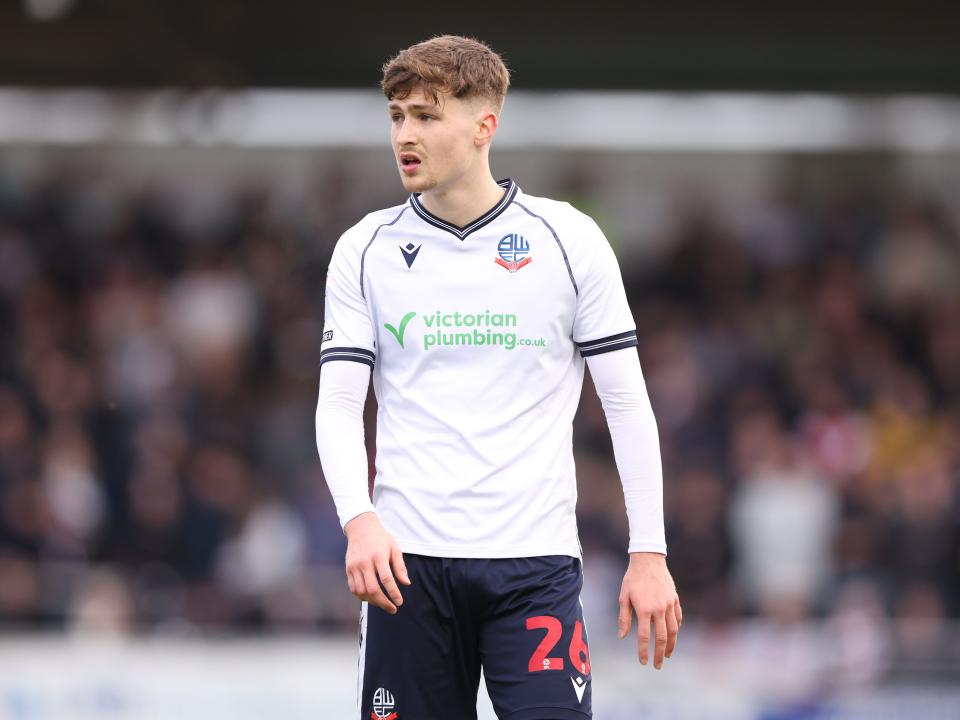 A photo of Zac Ashworth in action for loan club Bolton, in their white 23/24 home kit