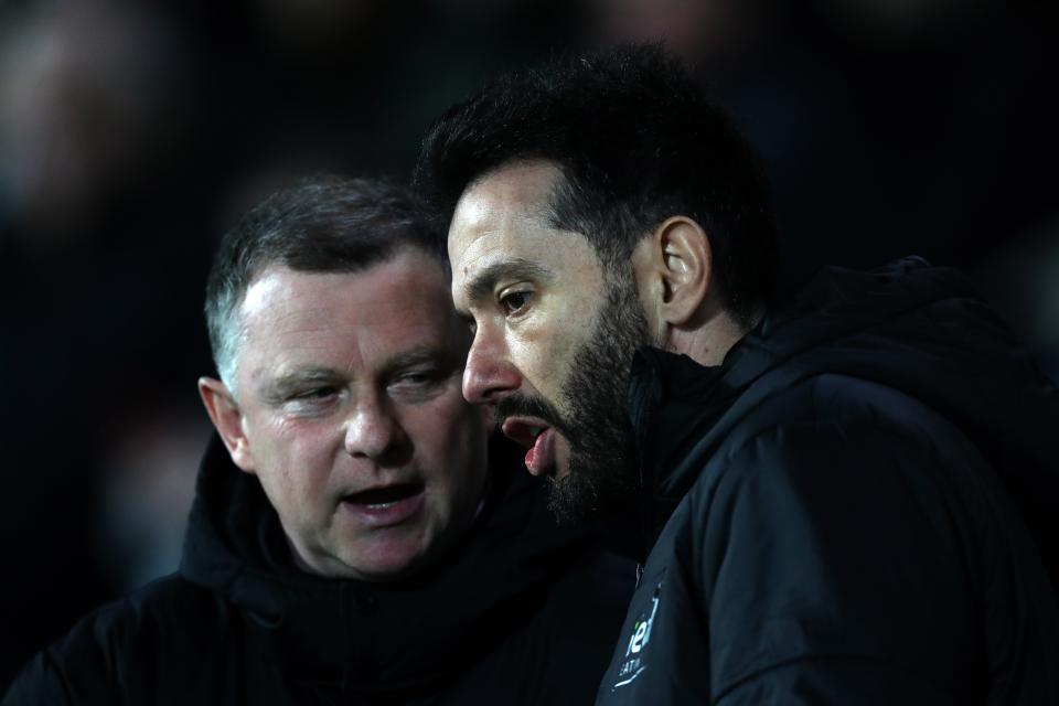 Coventry manager Mark Robins speaking to Albion manager Carlos Corberán before a match
