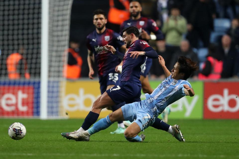 Alex Mowatt is challenged by a Coventry City player at the CBS Arena