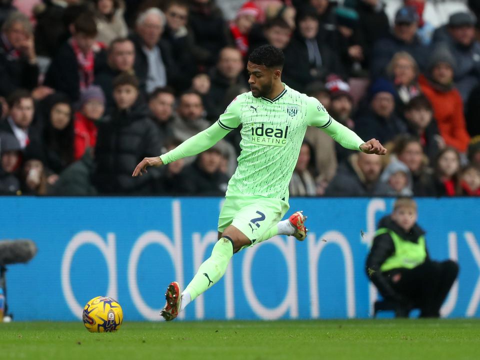 Darnell Furlong in action wearing the lime green kit
