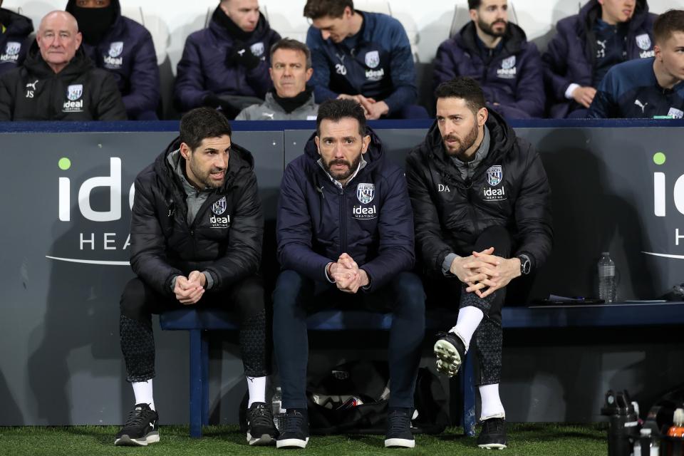Carlos Corberán sat in the dugout in the middle of Jorge Alarcon and Damia Abella