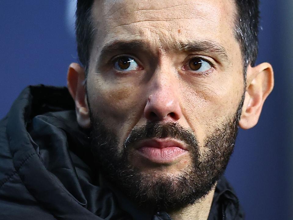 A close up of the front of Carlos Corberán's face
