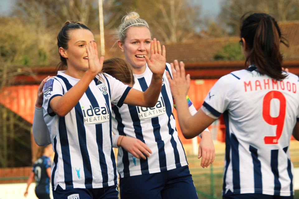Niamh Deasy celebrates scoring, in home Albion colours.