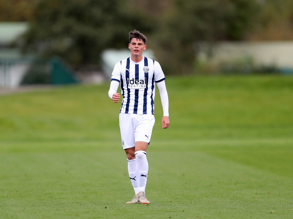 A photo of U18s midfielder Archie Kirton, in the 23/24 home kit, in action at the club's training ground
