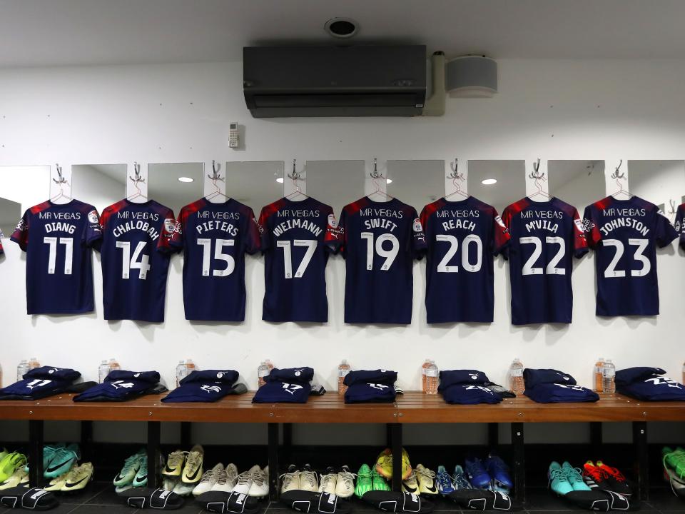 An image of Albion shirts hanging in the dressing room at QPR
