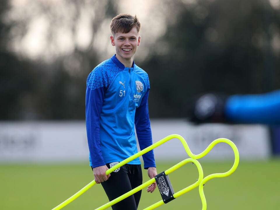 A photo of Albion youngster Fenton Heard in blue 23/24 training gear carrying a yellow mannequin