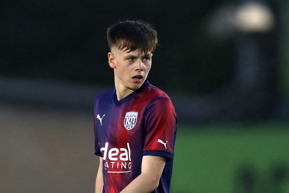 Fenton Heard in action for Albion wearing the navy-blue-and-red away kit