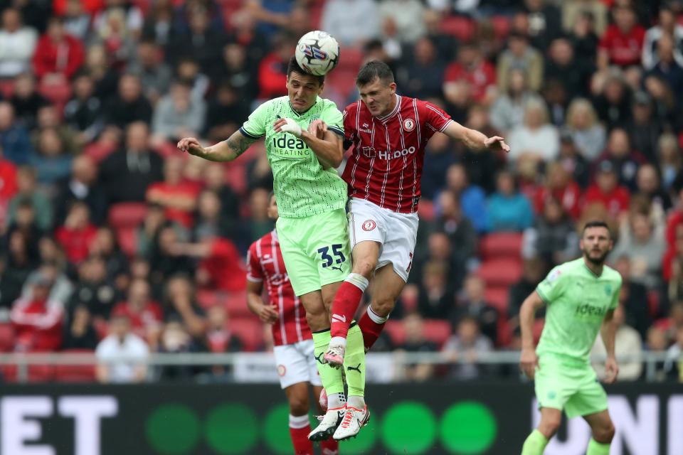 Okay Yokuslu jumping for the ball against Bristol City at Ashton Gate