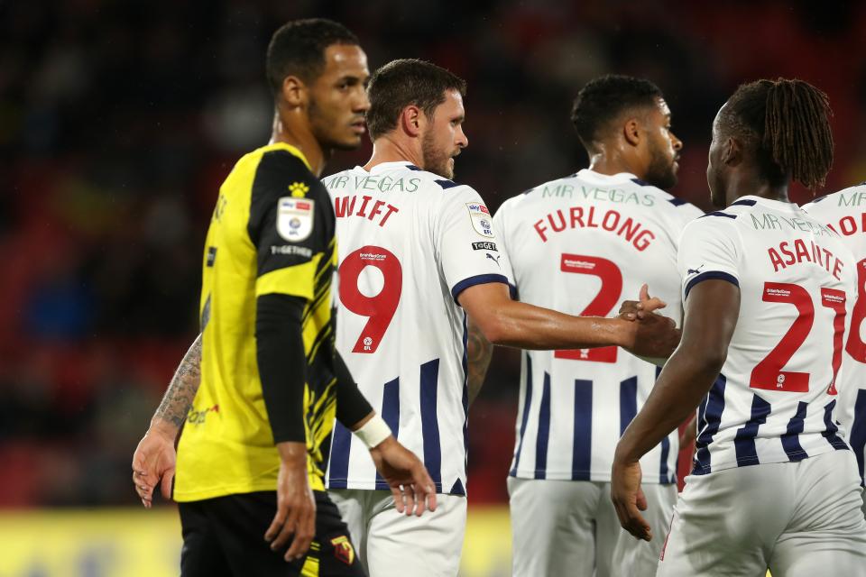 John Swift celebrates scoring a free-kick at Watford in September 2023 with Darnell Furlong and Brandon Thomas-Asante