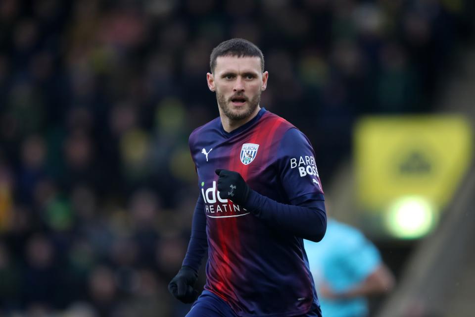 John Swift in action for Albion wearing the navy-blue-and-red away kit