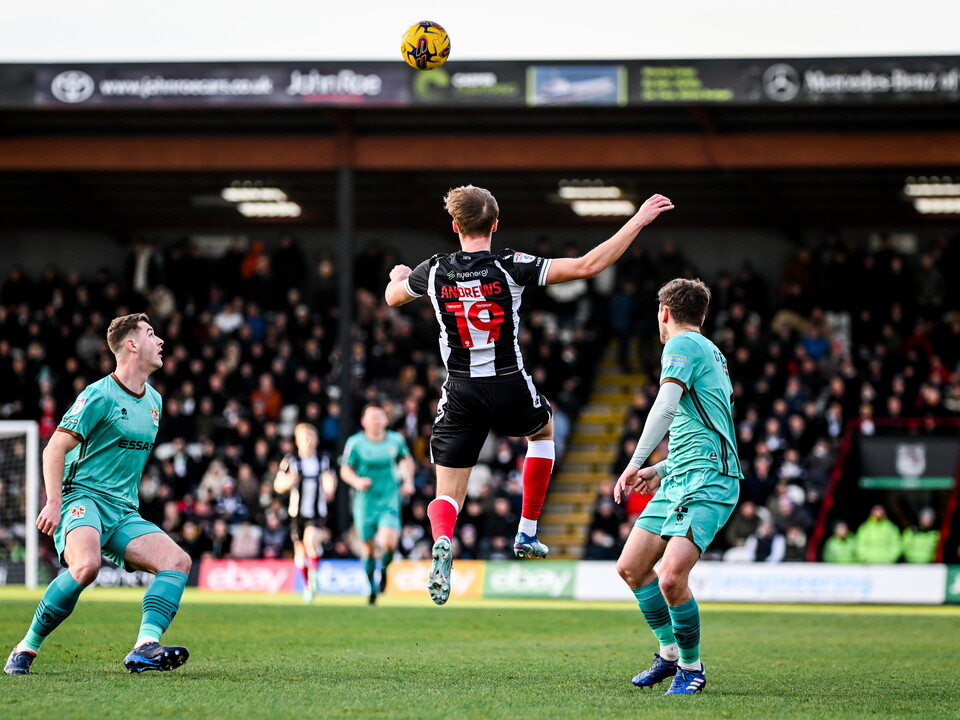 A photo of Albion youngster Jamie Andrews in action for loan club Grimsby Town in their black and white striped home kit