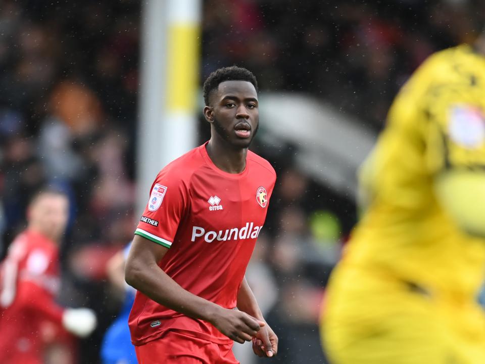 Mo Faal in action for Walsall wearing their red home shirt 