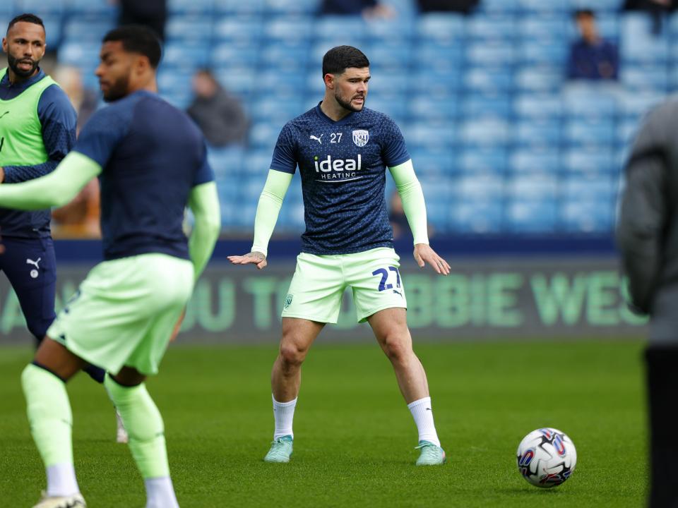 An image of Alex Mowatt warming up at Millwall