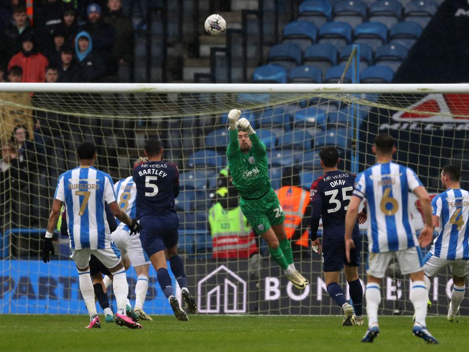 An image of Alex Palmer punching the ball against Huddersfield