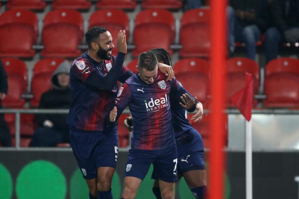 Jed Wallace celebrates scoring against Rotherham in the navy blue and red kit with Kyle Bartley