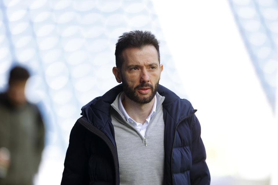 Carlos Corberán arriving at The Hawthorns before a game wearing a grey jumper and a dark coat