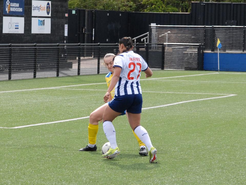 An image of Simran Jhamat taking on a defender