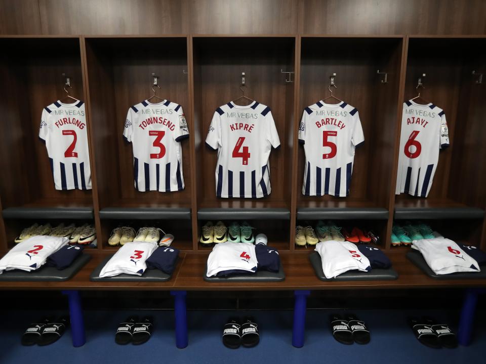 An image of five Albion shirts hanging in the away dressing room at Leicester
