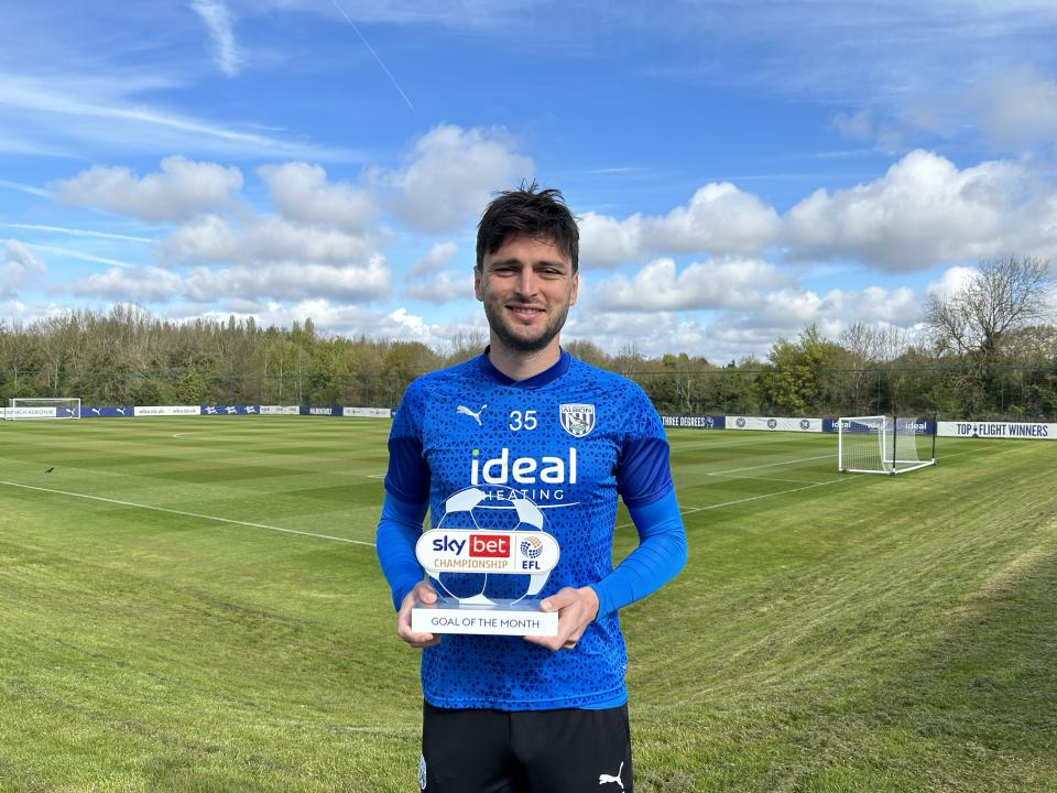 An image of Okay Yokuslu with his Goal of the Month Award