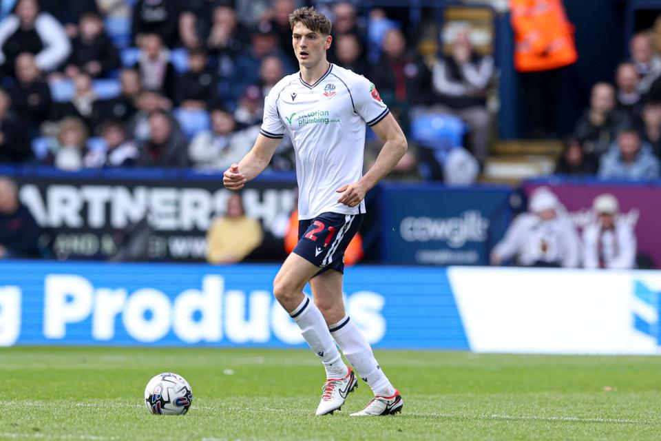 Caleb Taylor playing for Bolton while wearing their home kit