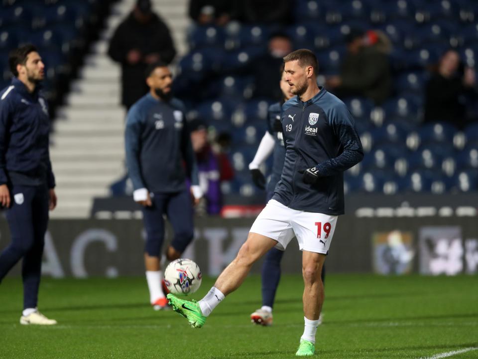 An image of John Swift warming up ahead of Albion's game against Rotherham