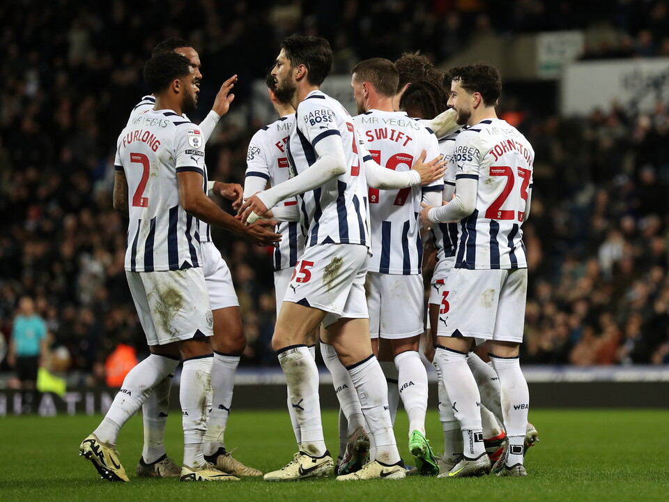 Several Albion players celebrate a goal at The Hawthorns wearing the home kit 