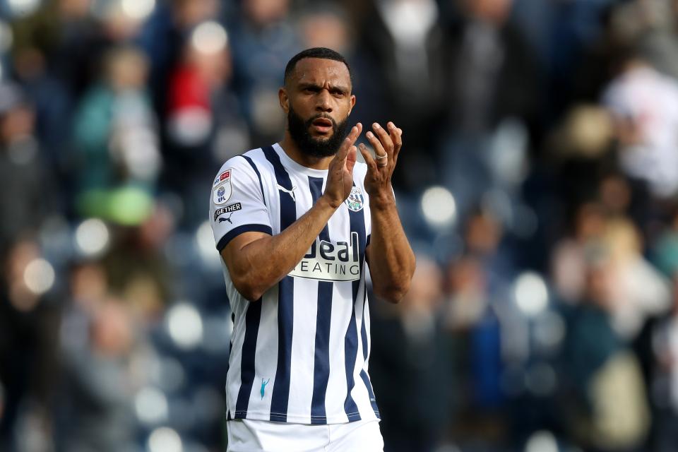 Matty Phillips applauding Albion fans while wearing the home kit 