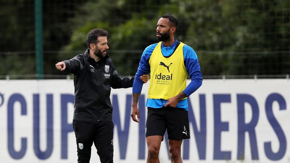 Carlos Corberán speaking to Kyle Bartley on the training pitch