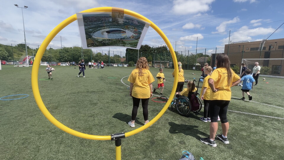 A wide shot of our SEND Festival, focused in on a hoop with one of the stadiums from the 2024 Euro's on.