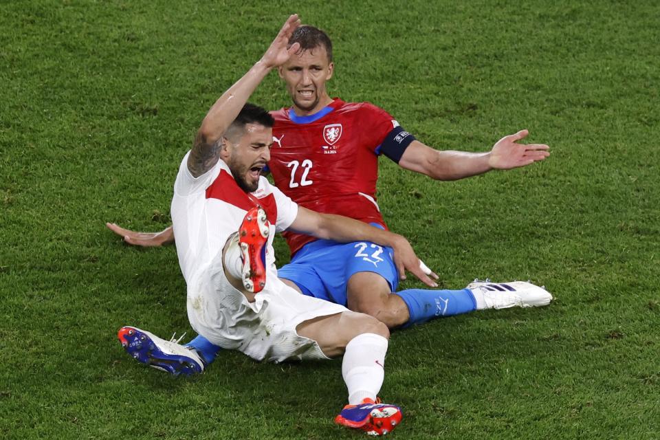 Okay Yokuslu challenges for the ball with a Czechia player during a UEFA EURO 2024 clash