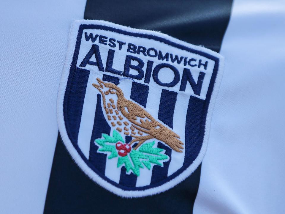 An image of the WBA crest on a shirt