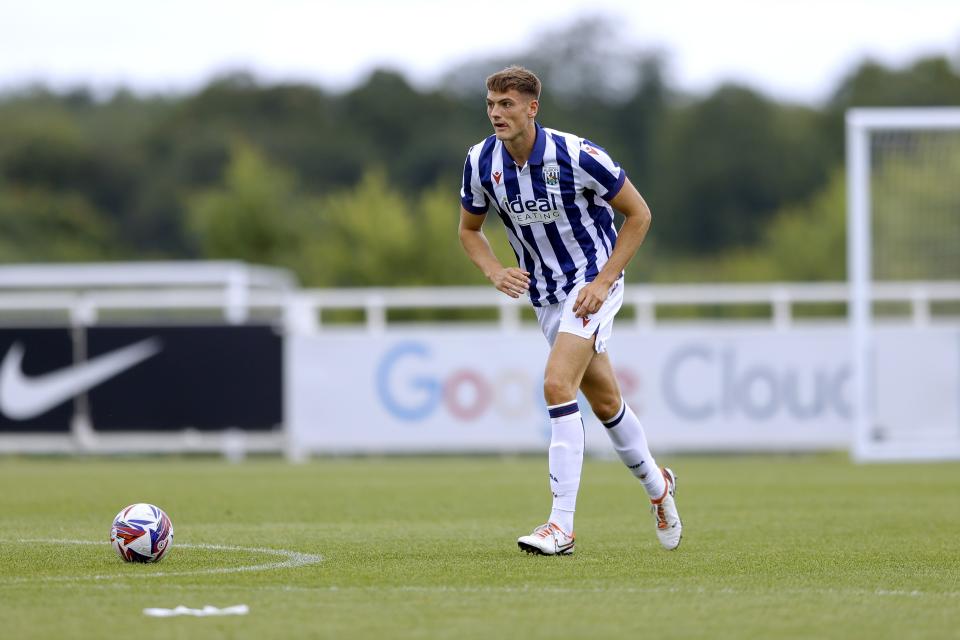 Caleb Taylor on the ball during a pre-season friendly wearing the home kit