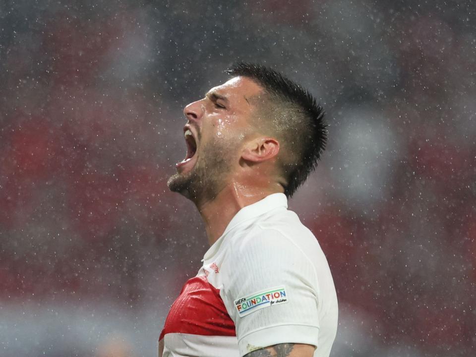 Okay Yokuslu celebrates after Turkiye beat Austria on Tuesday night 