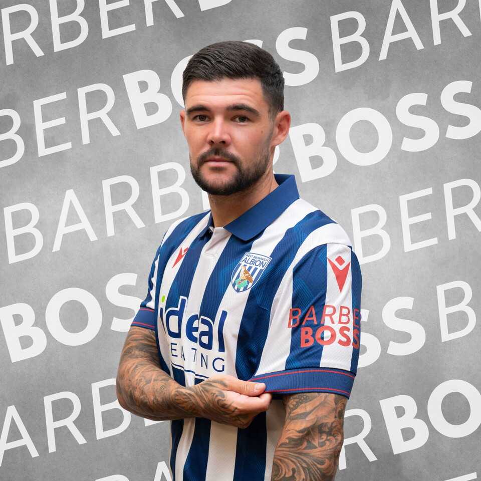 Alex Mowatt with the home shirt on, sponsored on the sleeve by BarberBoss.