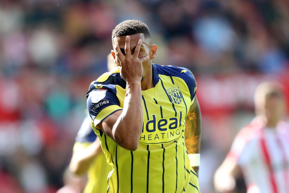 Karlan Grant celebrates after scoring at Stoke in the yellow away kit 