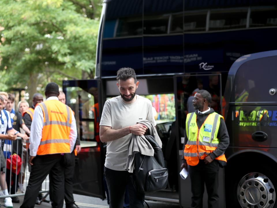 An image of Carlos Corberan stepping off the bus at QPR
