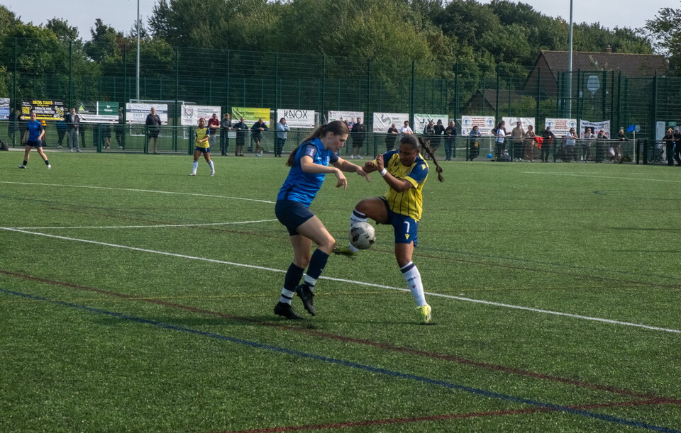 Simran Jhamat challenges for the ball against Liverpool Feds.