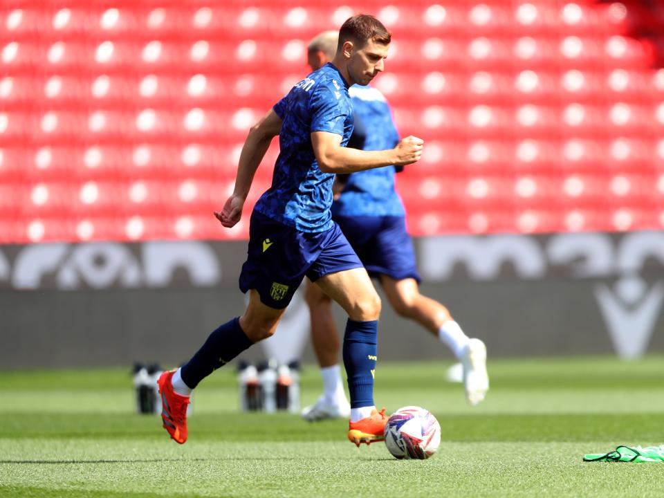 An image of Jayson Molumby warming up at the Bet365 Stadium