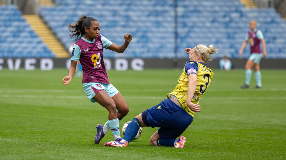 Hannah George slides into a tackle.