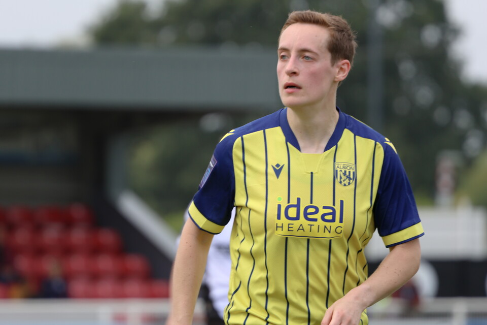 Ali Miller wearing Albion's yellow and blue kit.