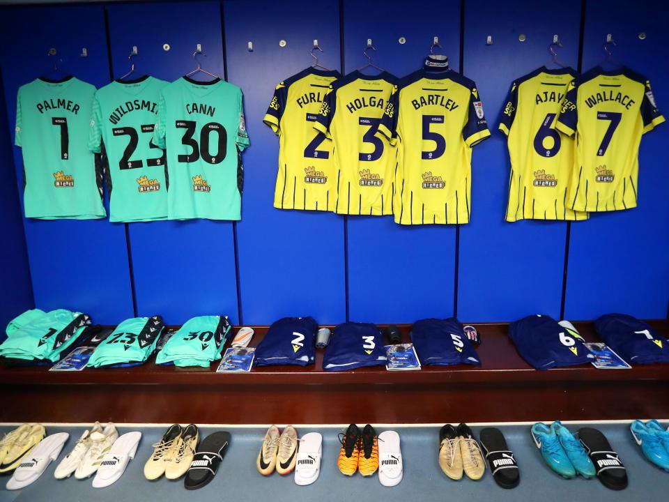 An image of shirts hanging up in the away dressing room at Fratton Park