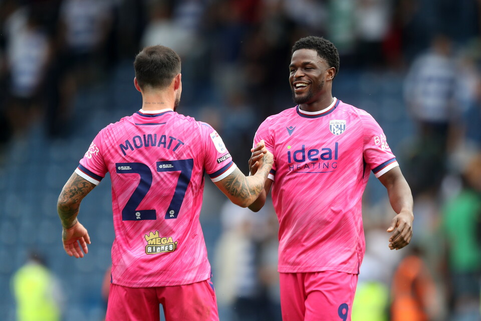 Josh Maja and Alex Mowatt shake hands while wearing the pink away kit 