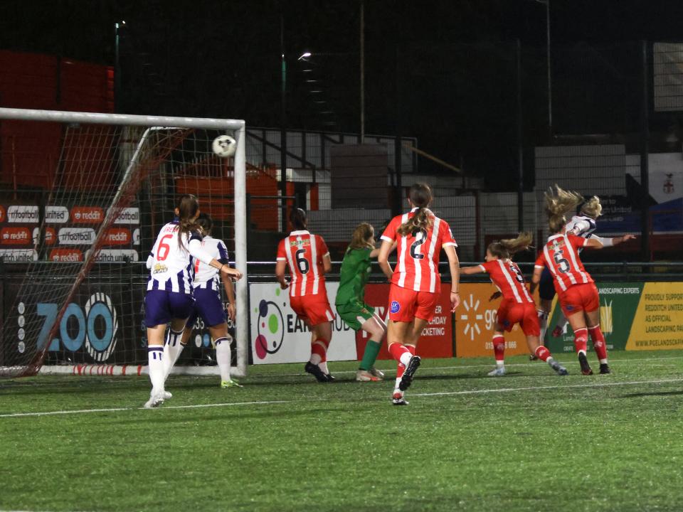 An image of Hannah George heading home a goal against Stourbridge