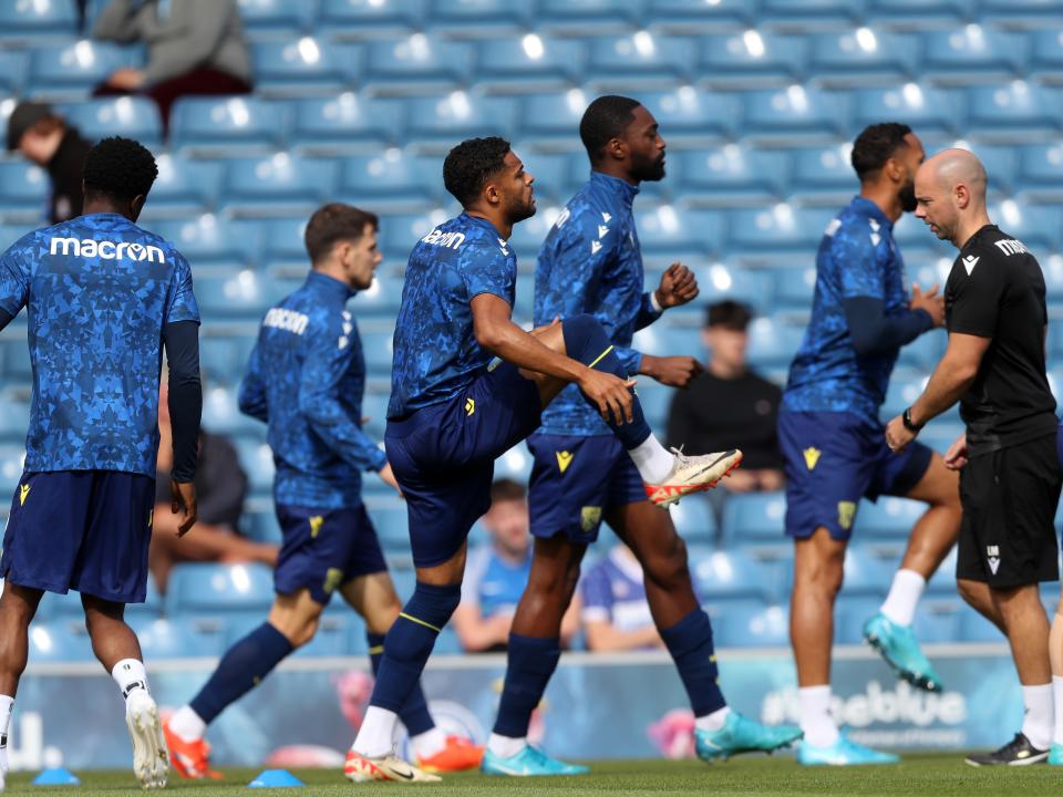 An image of Semi Ajayi and other Albion players warming up against Portsmouth