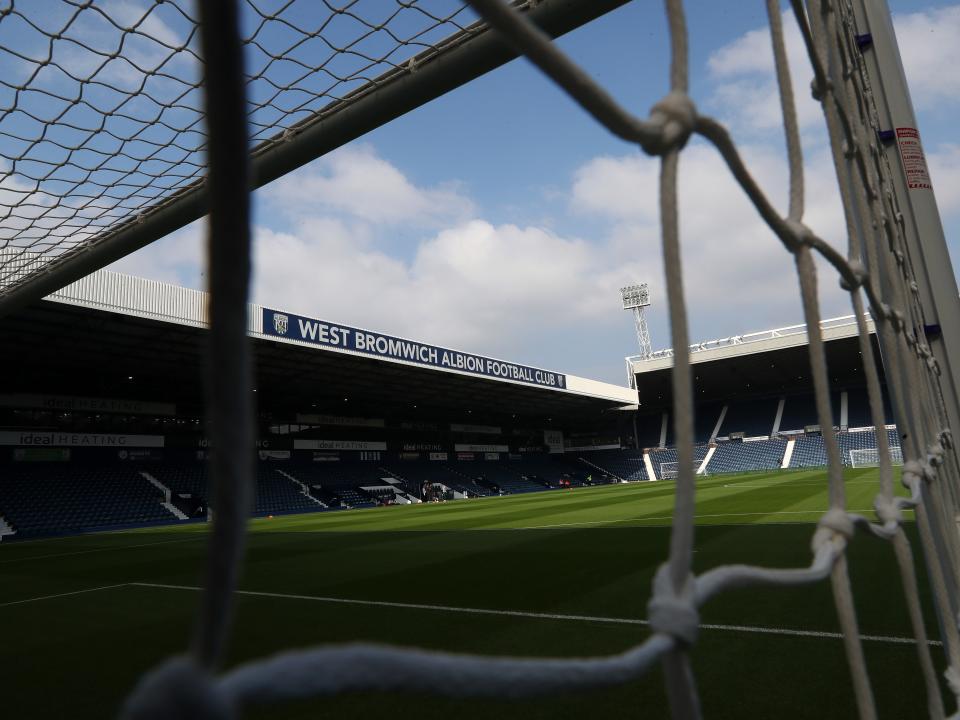 An image of The Hawthorns, specifically the West Stand, through a goal net