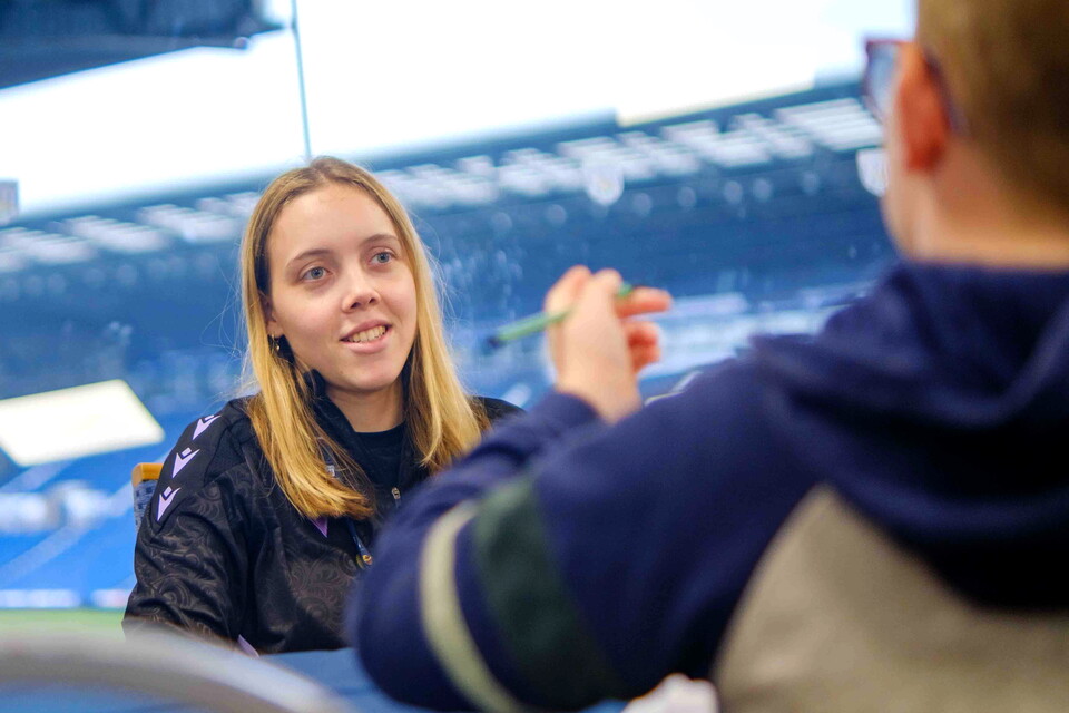 Foundation member of staff in conversation with a young person