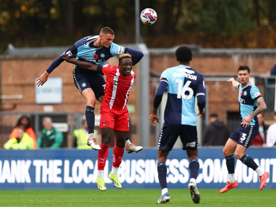 A photo of Caleb Taylor in action for loan club Wycombe, wearing their navy and sky blue home kit