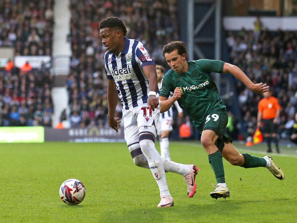 An image of Grady Diangana running past a Millwall player