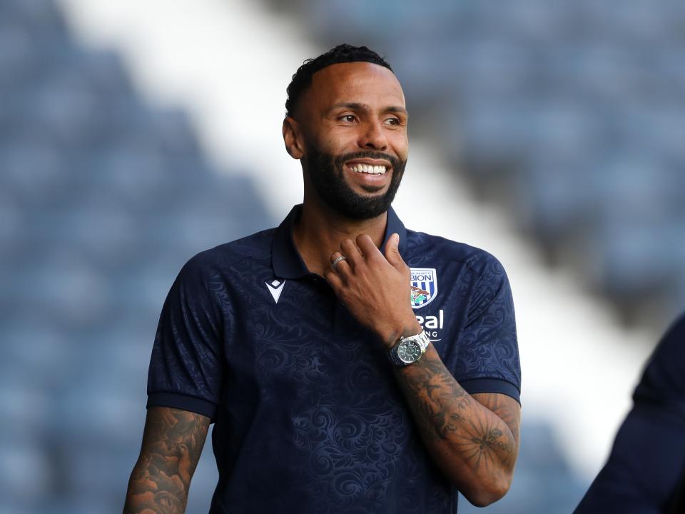An image of Kyle Bartley smiling upon arrival at The Hawthorns