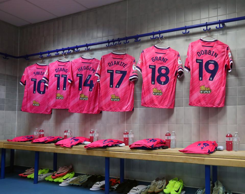 An image of Albion's pink shirts hanging in the dressing room at Blackburn